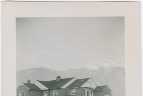 View of a house with mountains in the distance (ddr-densho-338-289)