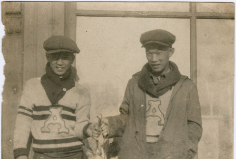 Two men holding a large fish (ddr-densho-430-188)