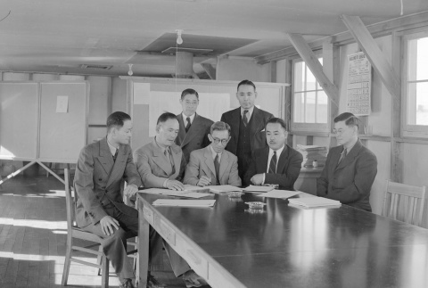Men signing documents in an office barracks (ddr-fom-1-384)