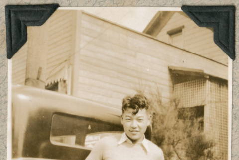 Dick Horita standing in front of car (ddr-densho-383-132)