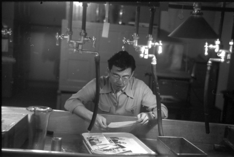 Frank Hirahara in developing room (ddr-one-1-566)