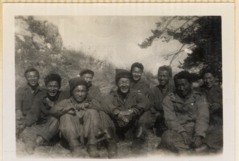Nine soldiers sitting on hillside (ddr-densho-466-242)