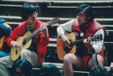 Kyle Kashima and Ted Hasegawa playing guitar at morning watch (ddr-densho-336-1313)