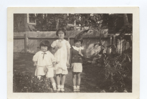 Three girls pose with their toys (ddr-one-6-6)