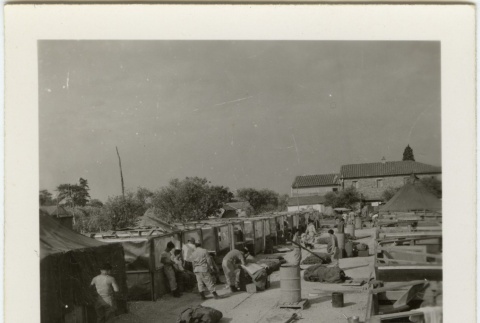 Soldiers dismantling tents in military encampment (ddr-densho-201-171)