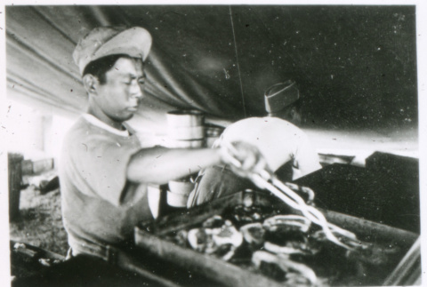 Grilling in tent (ddr-densho-1007-762)
