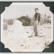 Man standing in snow by pile of snow (ddr-ajah-2-461)