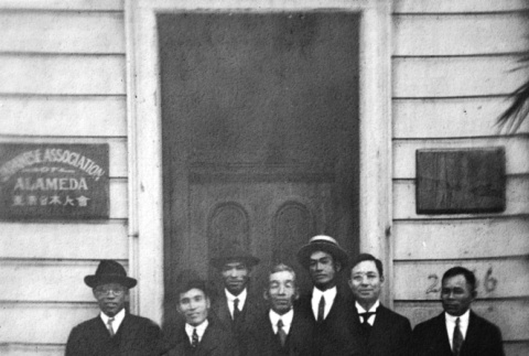 Group of men standing in doorway of school building (ddr-ajah-6-603)