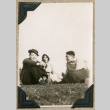 Three people sitting on grass (ddr-densho-383-109)