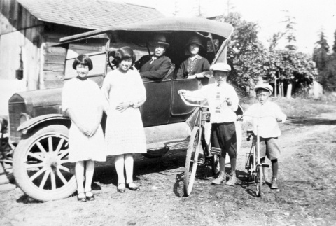 Family in front of a car (ddr-densho-9-6)