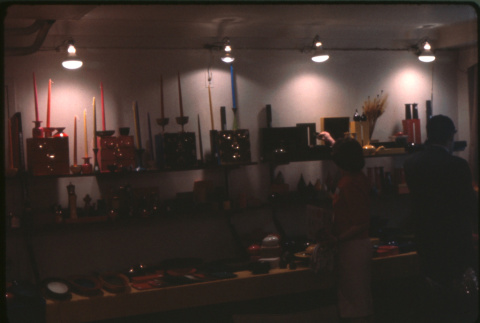 Two people looking at display of enamel and lacquerware (ddr-densho-426-349)