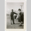 Man and woman standing in front of a car (ddr-manz-8-7)
