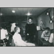 Young men talking and  playing chess (ddr-densho-523-388)