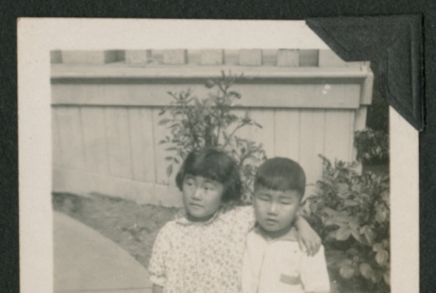 two kids sitting outside (ddr-densho-378-500)