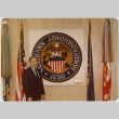 Frank Sato poses with Veterans Administration seal (ddr-densho-345-58)
