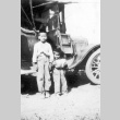 Two boys near a Model T Ford (ddr-densho-12-16)