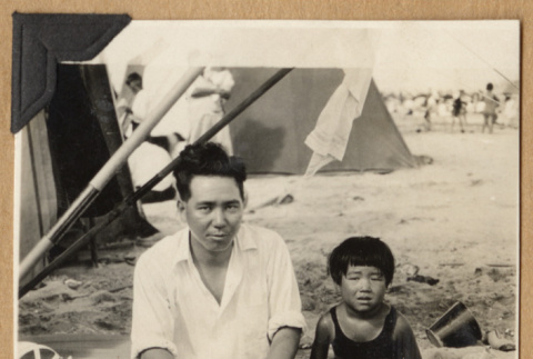 Man and child at a beach (ddr-densho-542-173)