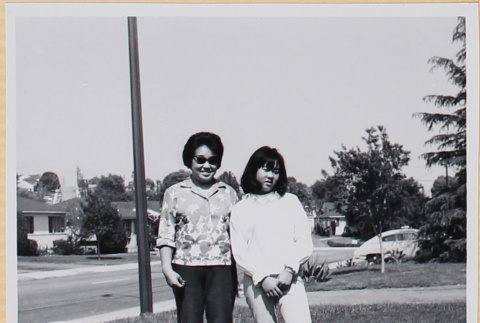 Woman and girl standing in yard (ddr-densho-522-107)