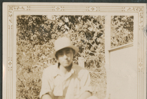 Man sitting on lawn (ddr-densho-316-269)