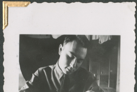 Man at desk writing (ddr-densho-434-48)