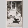 Woman holding baby sitting outside house (ddr-densho-464-133)