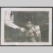 Photo of Kenji Ima holding an adult's hand (ddr-densho-483-824)