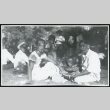 Photograph of men smoking cigars at a Manzanar hospital staff picnic (ddr-csujad-47-236)