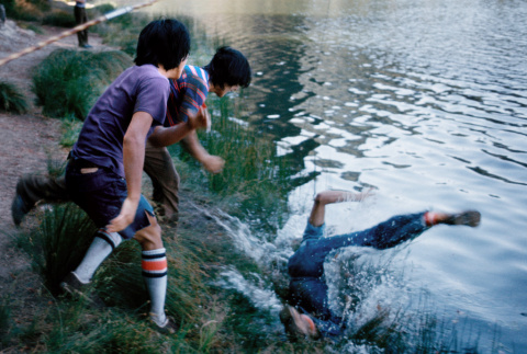 Group throwing a camper in the lake (ddr-densho-336-405)