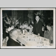 Seiso Bitow stands at a wedding banquet table (ddr-densho-395-14)