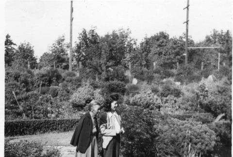 Two unidentified women in front of a pond in the Garden (ddr-densho-354-88)