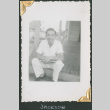 Man sitting on steps (ddr-densho-434-161)