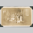Group photo of women and men outside wooden building (ddr-densho-483-552)