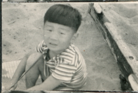 Boy sitting in sand (ddr-densho-523-114)
