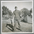 Man with rifle next to tents (ddr-densho-434-464)