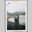 Photo of a woman holding a baby beside a lake (ddr-densho-483-1390)