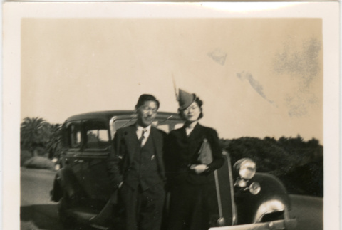 Tomoye (Nozawa) Takahashi and unknown man standing by car (ddr-densho-426-1619)
