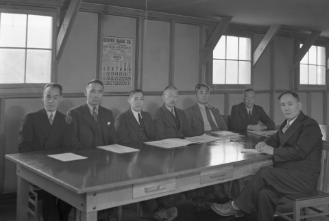 Men gathered around a table in an office barracks (ddr-fom-1-438)