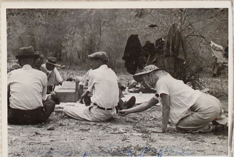 Six people sitting on ground at picnic (ddr-densho-464-53)