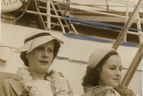 Paulette Goddard and another woman wearing leis on a ship (ddr-njpa-1-508)