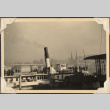 Boat at dock with city in background (ddr-densho-466-818)