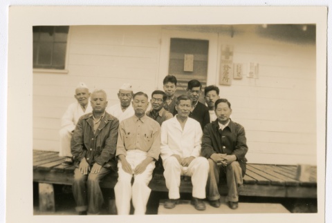 Large group of men posing in front of dispensary (ddr-densho-223-12)