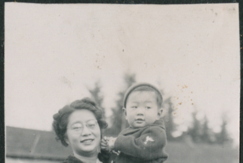 Woman holding toddler, likely Jon David Sakura (ddr-densho-523-72)