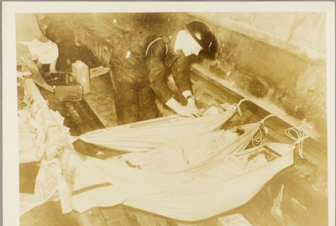 Air raid warden checking on children sleeping in a shelter (ddr-njpa-13-310)
