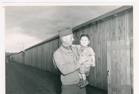 Serviceperson holding baby (ddr-densho-1007-210)