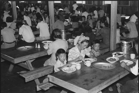 Japanese Americans eating in mess hall (ddr-densho-151-66)