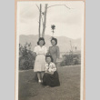 Three women standing on a lawn (ddr-manz-10-24)