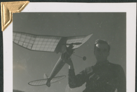 Man holding model glider (ddr-densho-434-140)