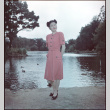 Woman in pink dress standing by pond (ddr-densho-426-937)
