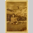 Woman sitting in front of a greenhouse (ddr-manz-6-103)