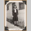 Girl standing by a picket fence (ddr-densho-542-215)